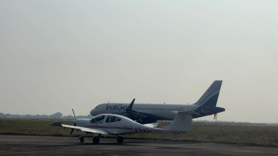 An IFA training aircraft taxiing at Khajuraho with an airline aircraft in the background